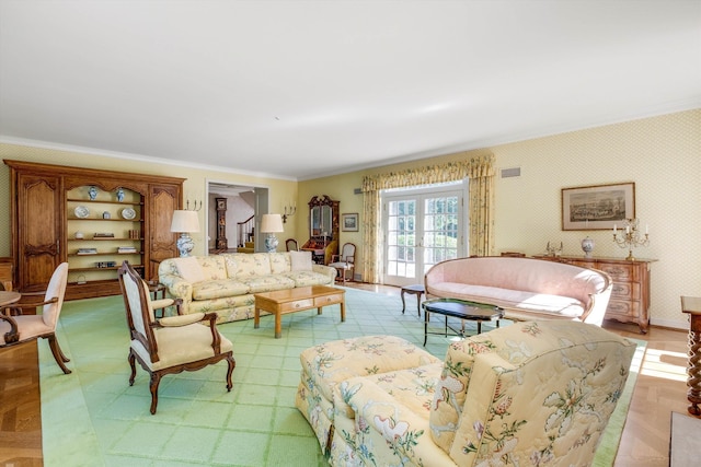 living room with light parquet floors, ornamental molding, and french doors