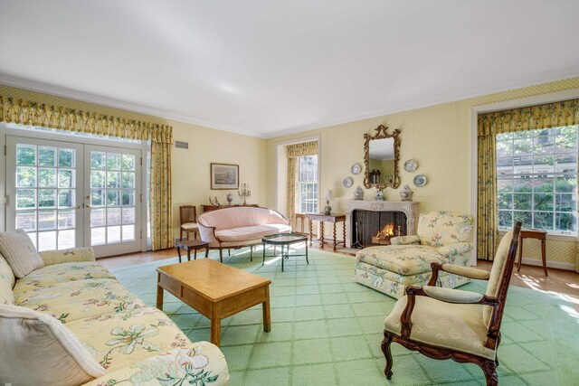 living room featuring ornamental molding, french doors, and a healthy amount of sunlight