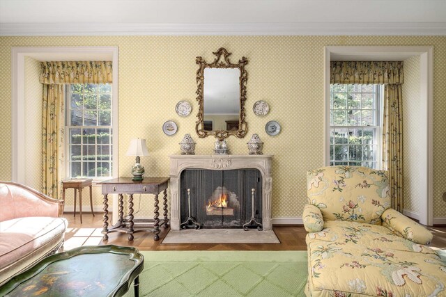 living room featuring crown molding, a healthy amount of sunlight, and hardwood / wood-style floors