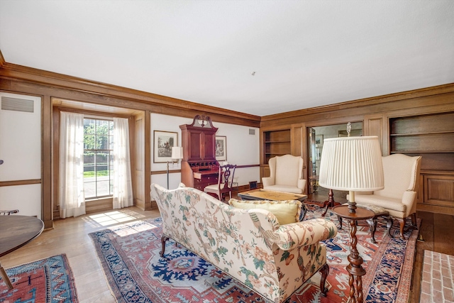 living room featuring light hardwood / wood-style flooring and ornamental molding