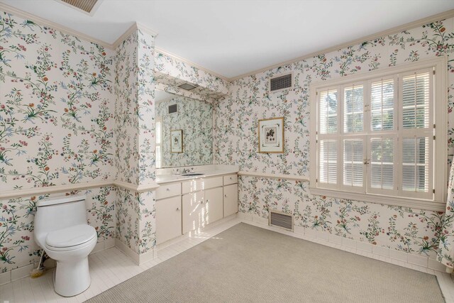 bathroom featuring ornamental molding, vanity, and toilet