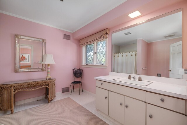 bathroom with crown molding, vanity, and tile patterned flooring