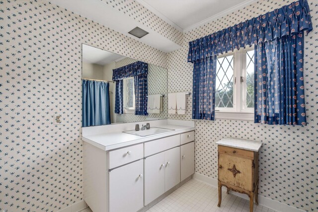 bathroom with tile patterned flooring, walk in shower, crown molding, and vanity