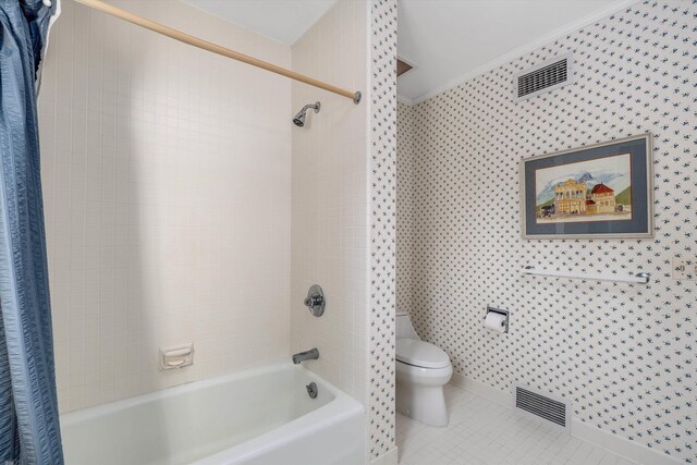 bathroom featuring crown molding, shower / bath combo with shower curtain, toilet, and tile patterned floors