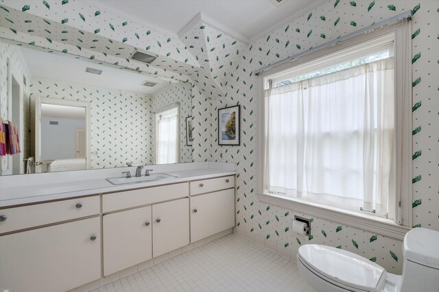 bathroom featuring vanity, toilet, ornamental molding, and tile patterned floors