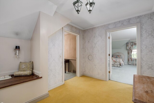 corridor featuring light colored carpet and ornamental molding