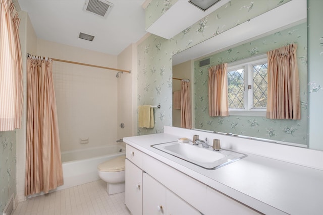 full bathroom featuring tile patterned flooring, vanity, toilet, and shower / tub combo