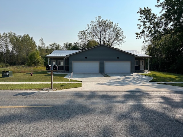 single story home featuring a front lawn and a garage