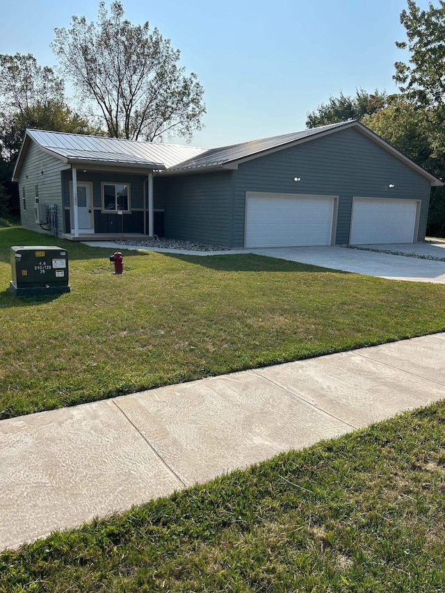 view of front of home featuring a garage, a porch, and a front lawn