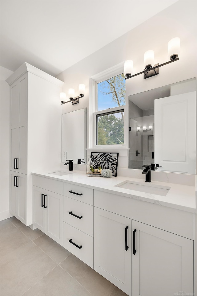 bathroom featuring an enclosed shower, vanity, and tile patterned floors