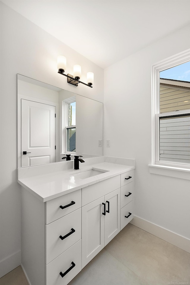 bathroom featuring vanity, concrete floors, and plenty of natural light