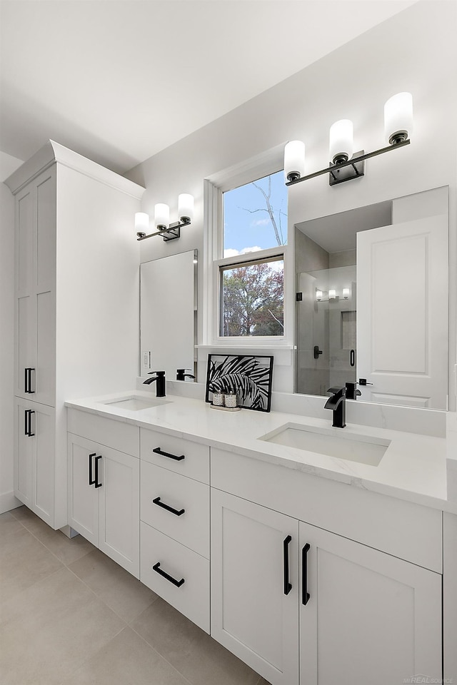 bathroom featuring walk in shower, vanity, and tile patterned floors