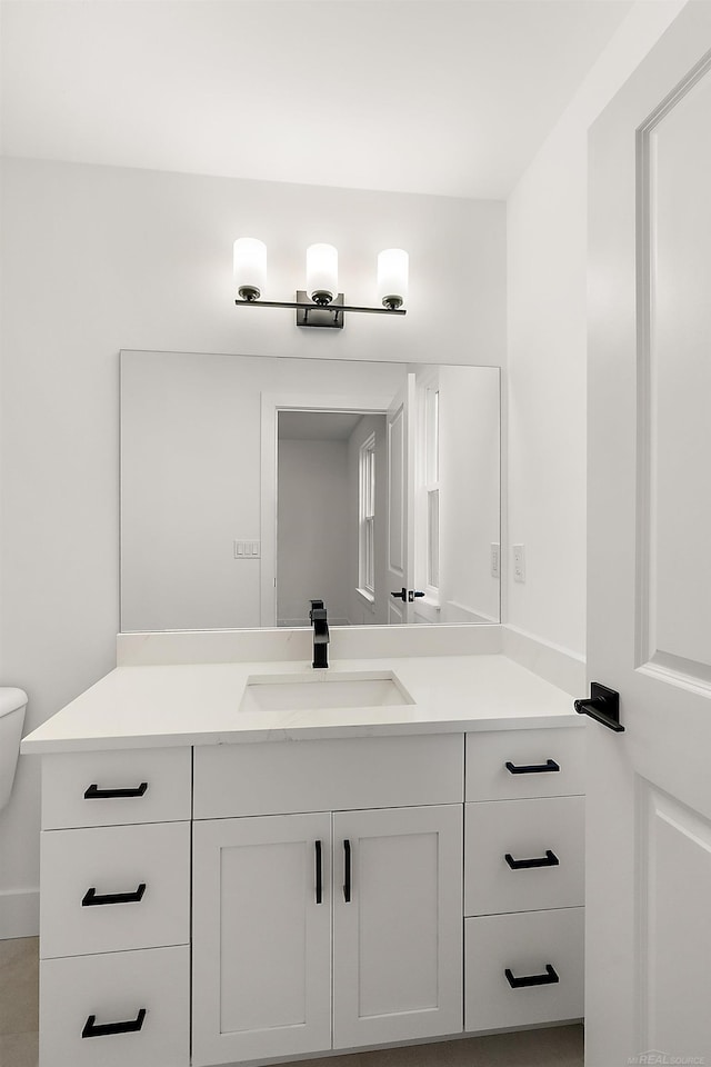 bathroom featuring toilet and vanity