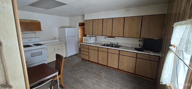 904 W A St, Iron Mountain, MI 49801 - kitchen featuring white appliances, a drop ceiling, a sink, light countertops, and brown cabinets