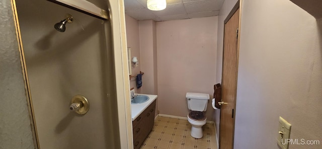 904 W A St, Iron Mountain, MI 49801 - full bathroom with a drop ceiling, tile patterned floors, toilet, vanity, and a shower