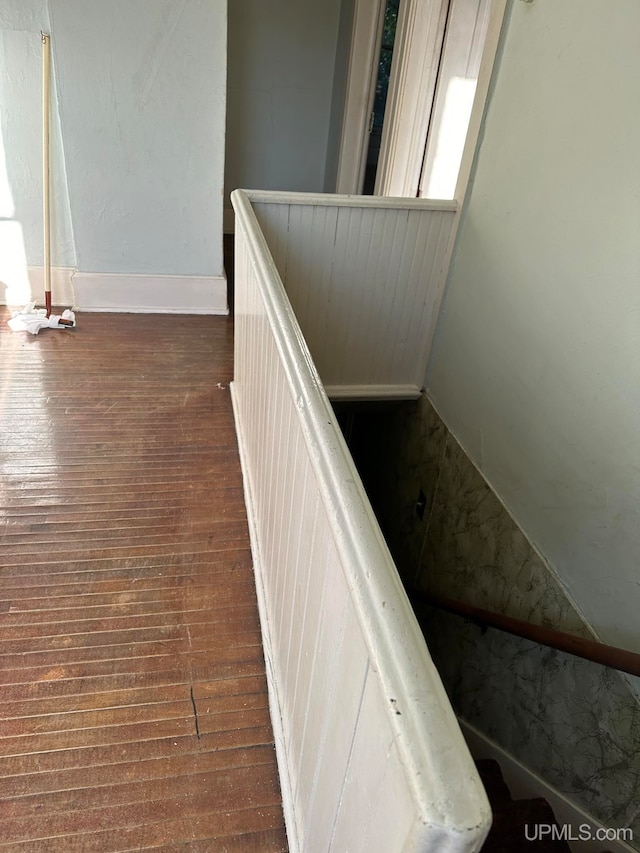 stairway with hardwood / wood-style floors