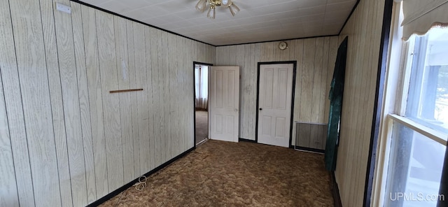 904 W A St, Iron Mountain, MI 49801 - unfurnished bedroom featuring carpet flooring and wood walls
