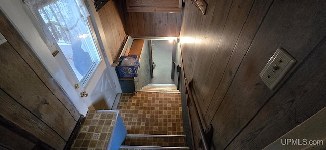 staircase with wooden walls