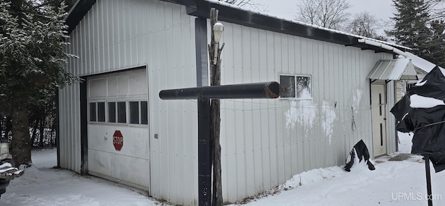 view of snowy exterior with an outbuilding