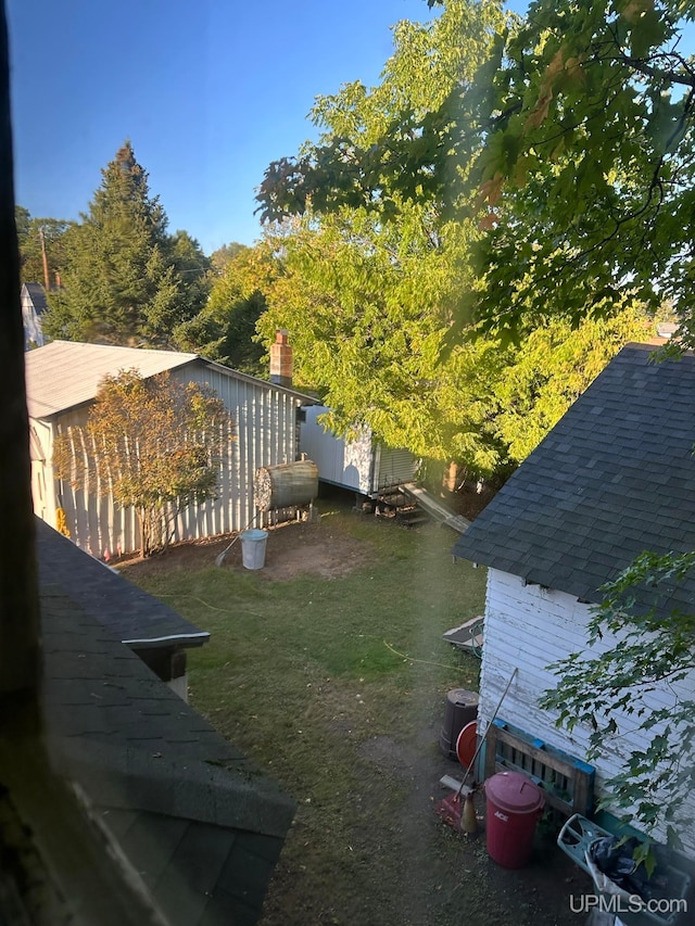 view of yard with a storage shed and central AC