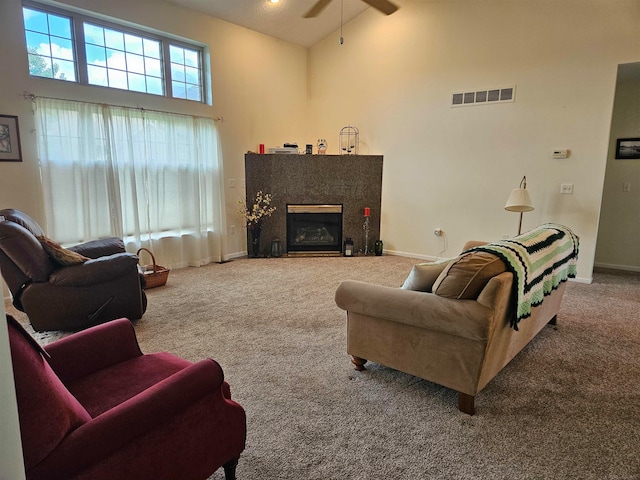 carpeted living room with ceiling fan, beamed ceiling, and high vaulted ceiling