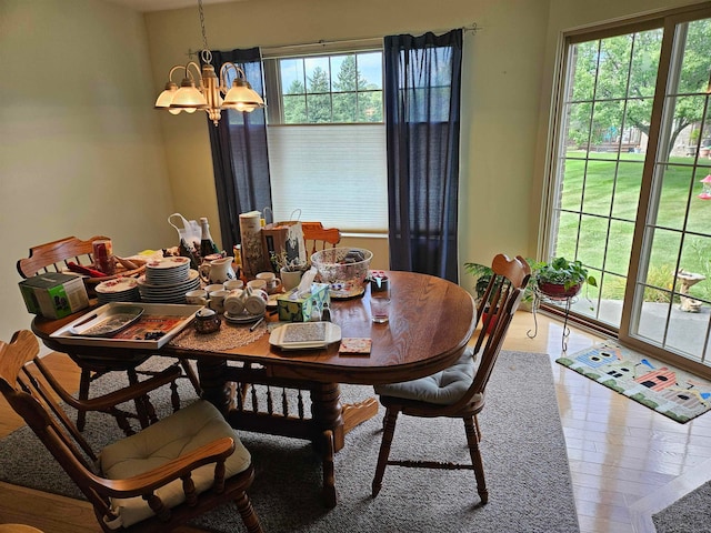 dining room featuring hardwood / wood-style flooring and a chandelier