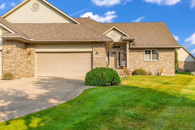 view of front of home featuring a front yard and a garage