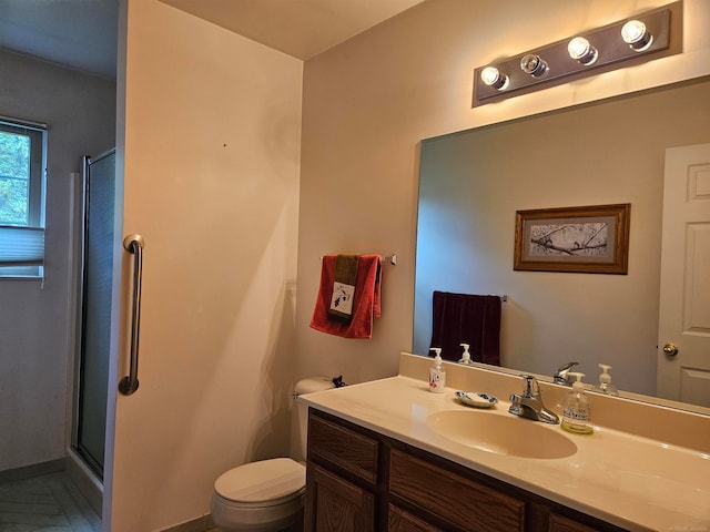 bathroom with vanity, toilet, and walk in shower