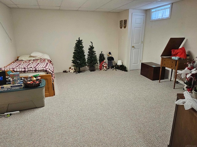 bedroom with a paneled ceiling and carpet