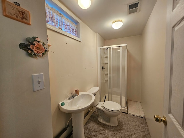 bathroom with a shower with door, toilet, and tile patterned flooring