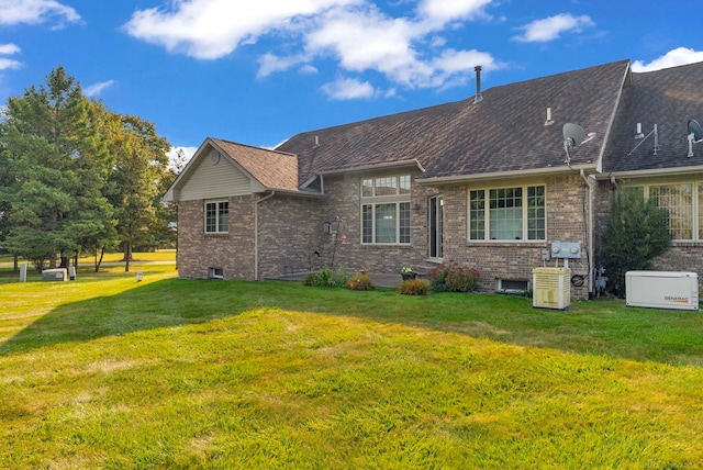 back of house with a lawn