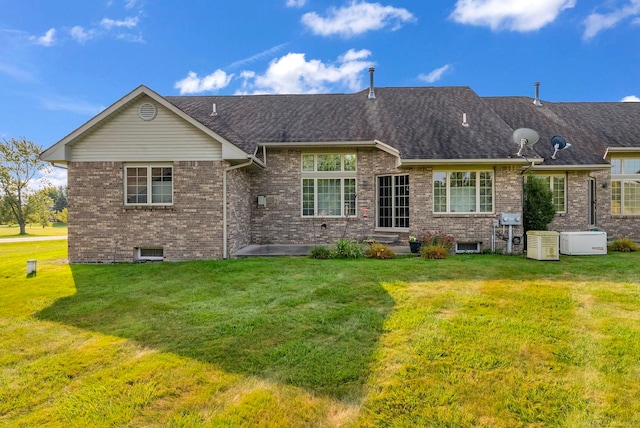 rear view of house featuring a yard