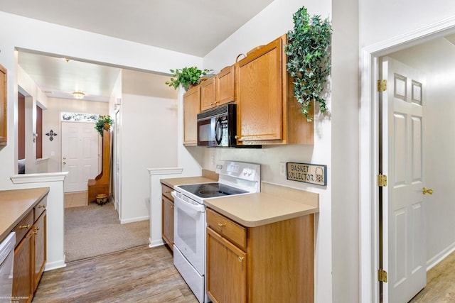 kitchen featuring white appliances and light hardwood / wood-style floors