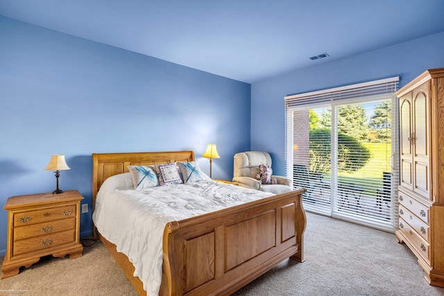 bedroom featuring access to outside and light colored carpet