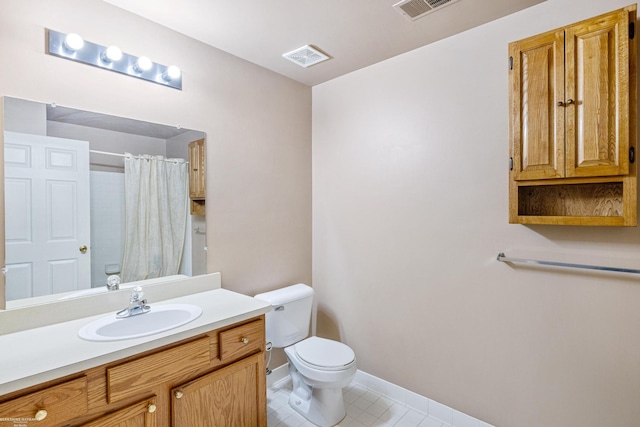 bathroom with curtained shower, tile patterned flooring, toilet, and vanity