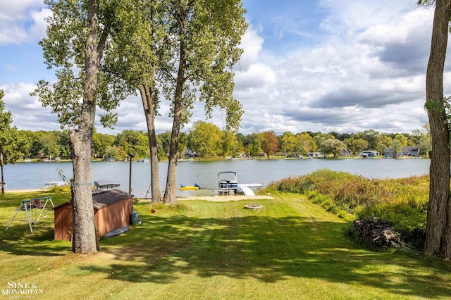 view of yard featuring a boat dock and a water view