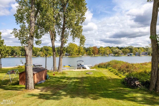 2771 Hemlock Rd, Quincy, MI 49082 - view of grassy yard featuring a water view and a dock
