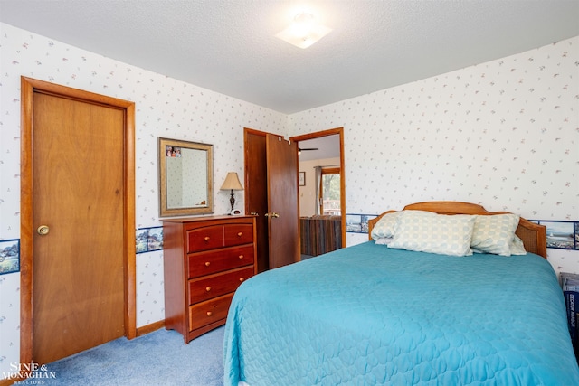 carpeted bedroom featuring a textured ceiling