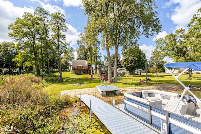 view of dock featuring a lawn