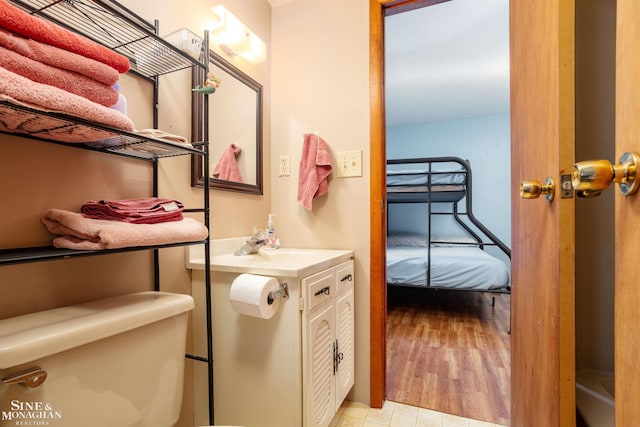 bathroom featuring vanity, toilet, and hardwood / wood-style floors