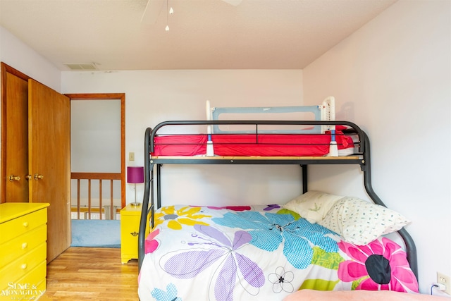 bedroom with ceiling fan and light hardwood / wood-style floors