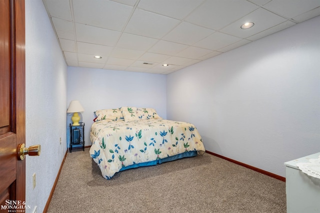 bedroom featuring carpet flooring and a paneled ceiling