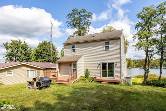 back of house featuring a yard, a deck with water view, and central air condition unit