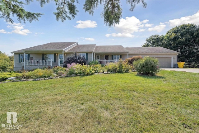 ranch-style house featuring a garage, a front lawn, and covered porch