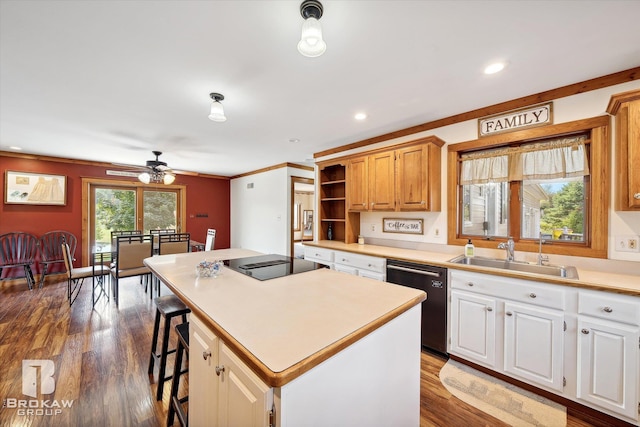 kitchen with dishwasher, a center island, hardwood / wood-style floors, sink, and ceiling fan