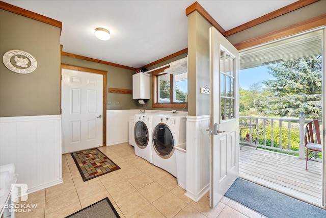 laundry area featuring water heater, cabinets, independent washer and dryer, and light tile patterned flooring