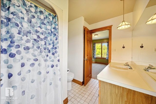 bathroom with vanity, toilet, and tile patterned floors