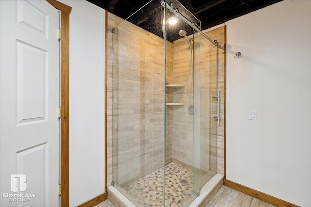 bathroom featuring walk in shower and hardwood / wood-style flooring