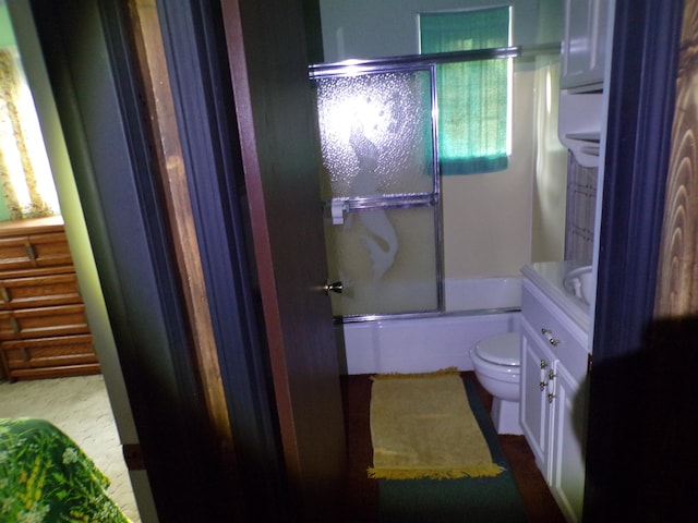 full bathroom with vanity, toilet, and bath / shower combo with glass door