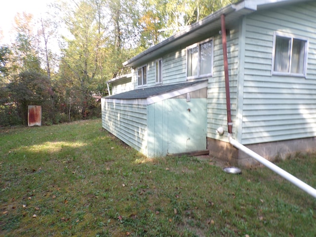 view of side of home with a yard